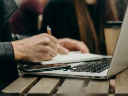 freelancer working at a table with his laptop and Everbook for great freelance analog productivity