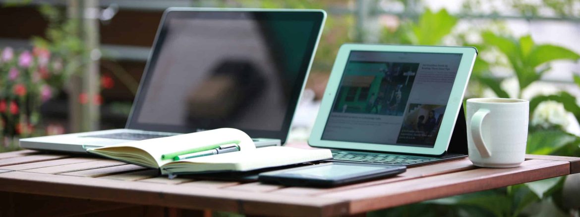A desk with a notebook, an ipad, and an everbook for maximum remote-work productivity