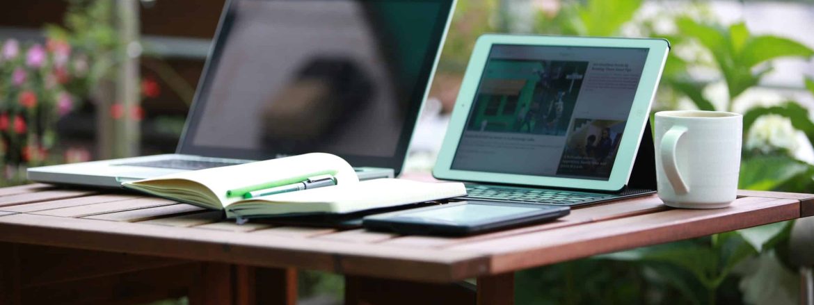 A desk with a notebook, an ipad, and an everbook for maximum remote-work productivity