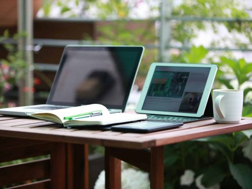 A desk with a notebook, an ipad, and an everbook for maximum remote-work productivity